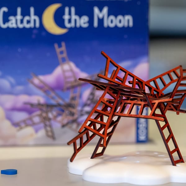 A red wooden ladder structure from the game "Catch the Moon" on a white cloud base.