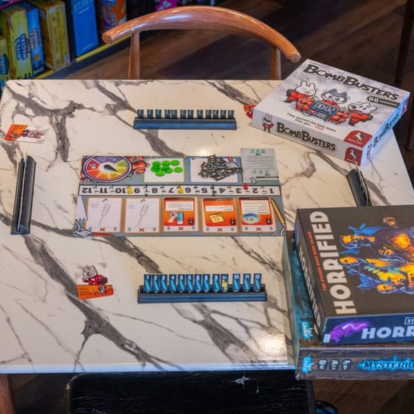 A BombBusters board game set up on a marble table at The Board and Brew cafe.